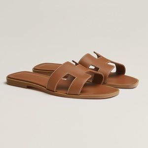 Hermes Oran H Sandals in Gold/Brown